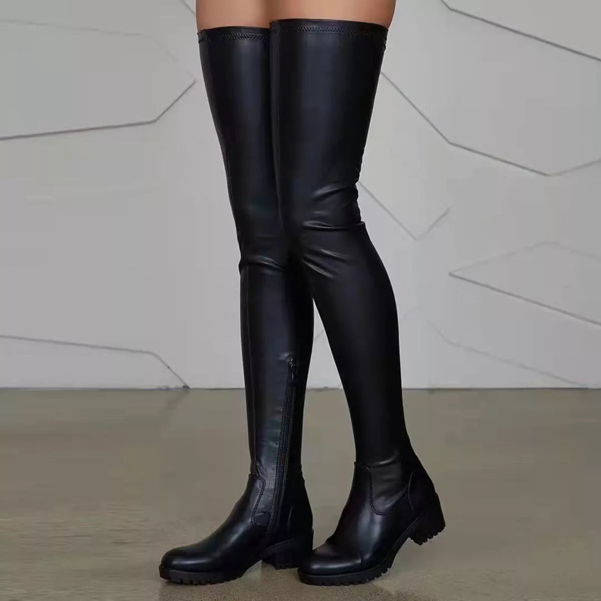 Over-the-knee block heel boots by Trendsi showcasing sleek black footwear with tall shaft and chunky heels, stylish and modern.
