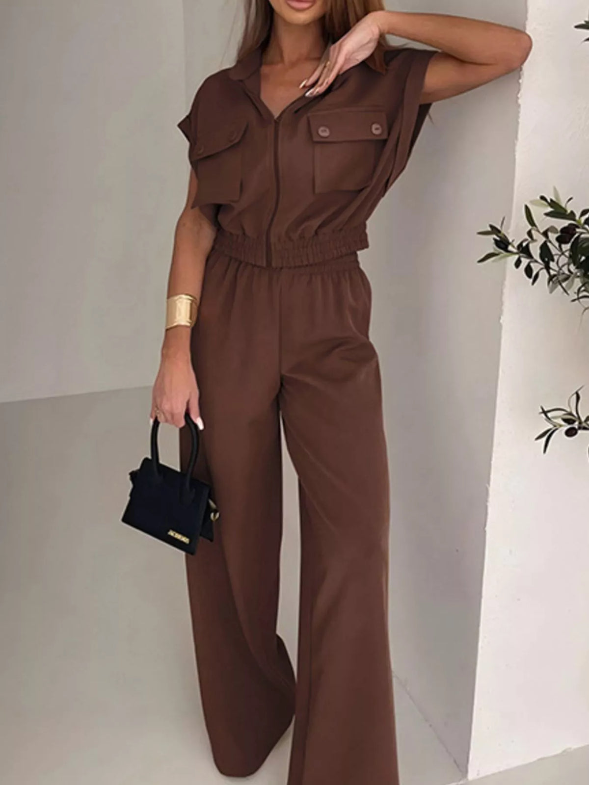 Black cargo pocket zipper front jumpsuit by Plush Fashion Hub, featuring utility style, front zipper, and multiple pockets.