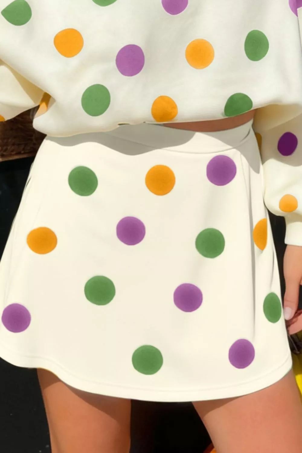 Polka dot V-neck top and matching skirt set by Plush Fashion Hub, stylish outfit with a playful dot pattern and feminine fit.
