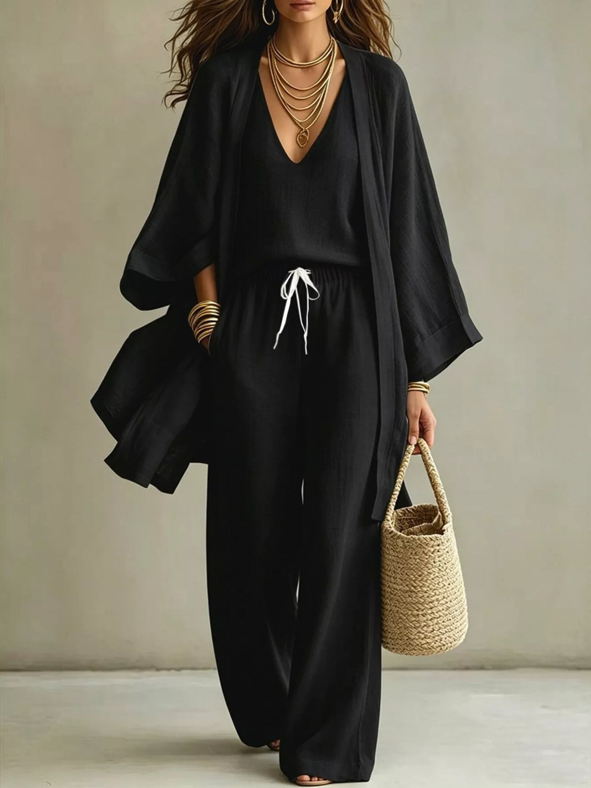 Plus size V-neck tank cardigan and pants loungewear set by Trendsi, featuring a comfortable, coordinated casual outfit.