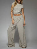 Striped crop top and wide-leg pants set by Trendsi, casual dress with stylish horizontal stripe pattern and relaxed fit.