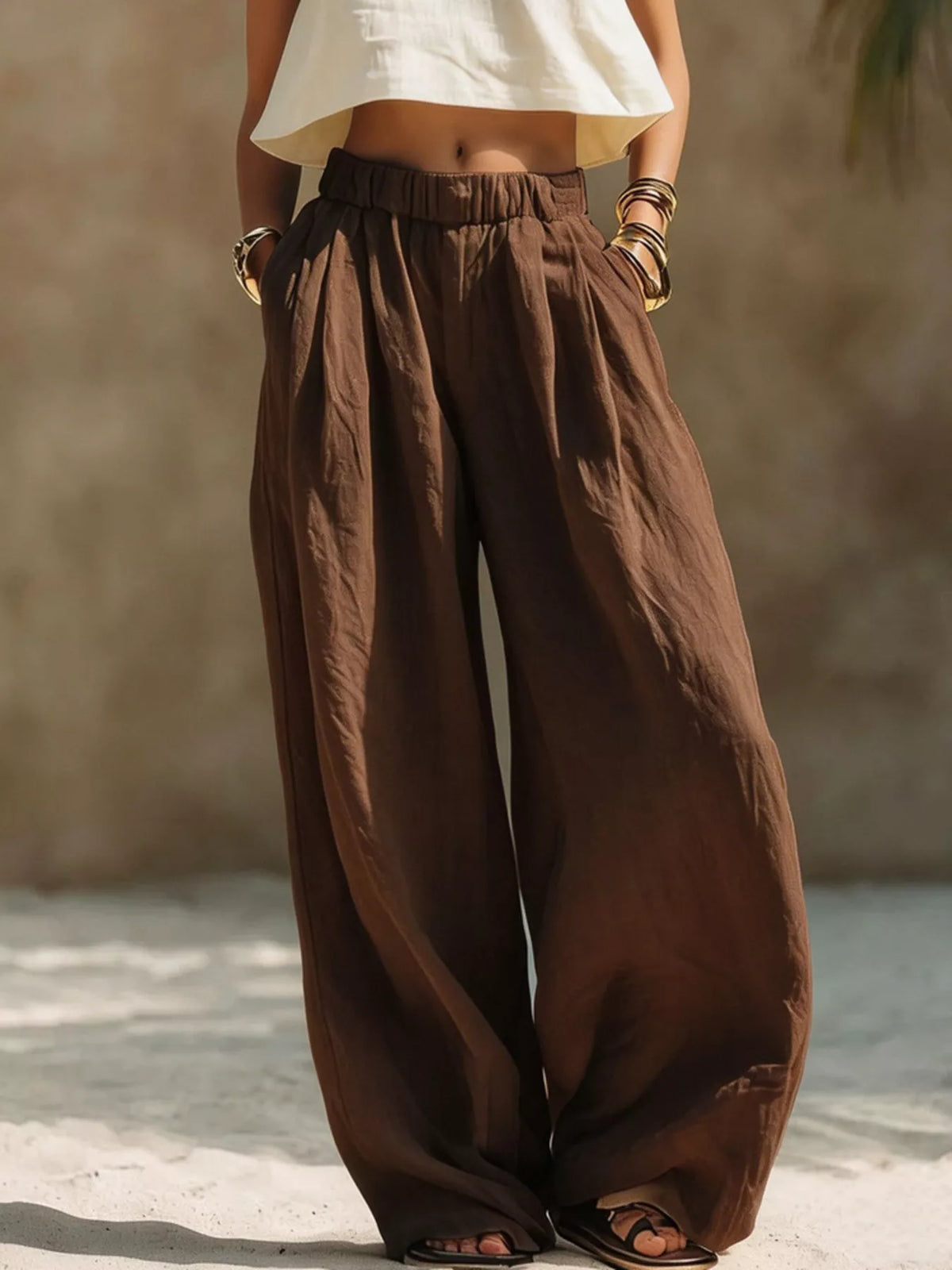 Plus size wide-leg pants with full elastic waistband, made by Trendsi, featuring a comfortable and flowing fit.