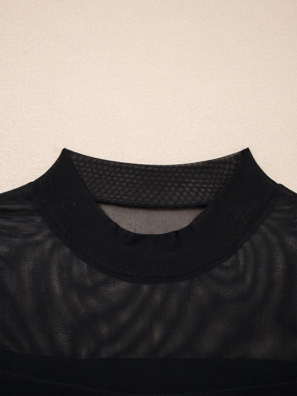 Women's sheer mesh patchwork cap sleeve T-shirt by Trendsi featuring elegant layering, with visible mesh fabric and patchwork design.