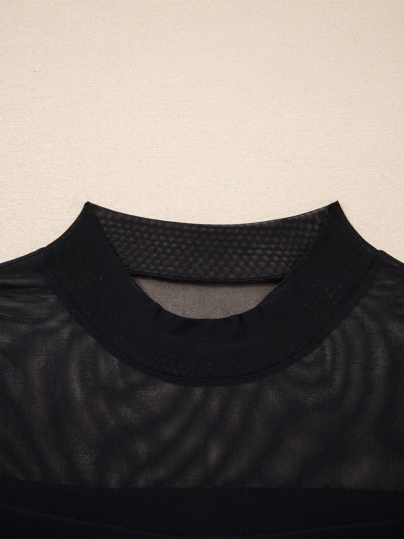 Women's sheer mesh patchwork cap sleeve T-shirt by Trendsi featuring elegant layering, with visible mesh fabric and patchwork design.