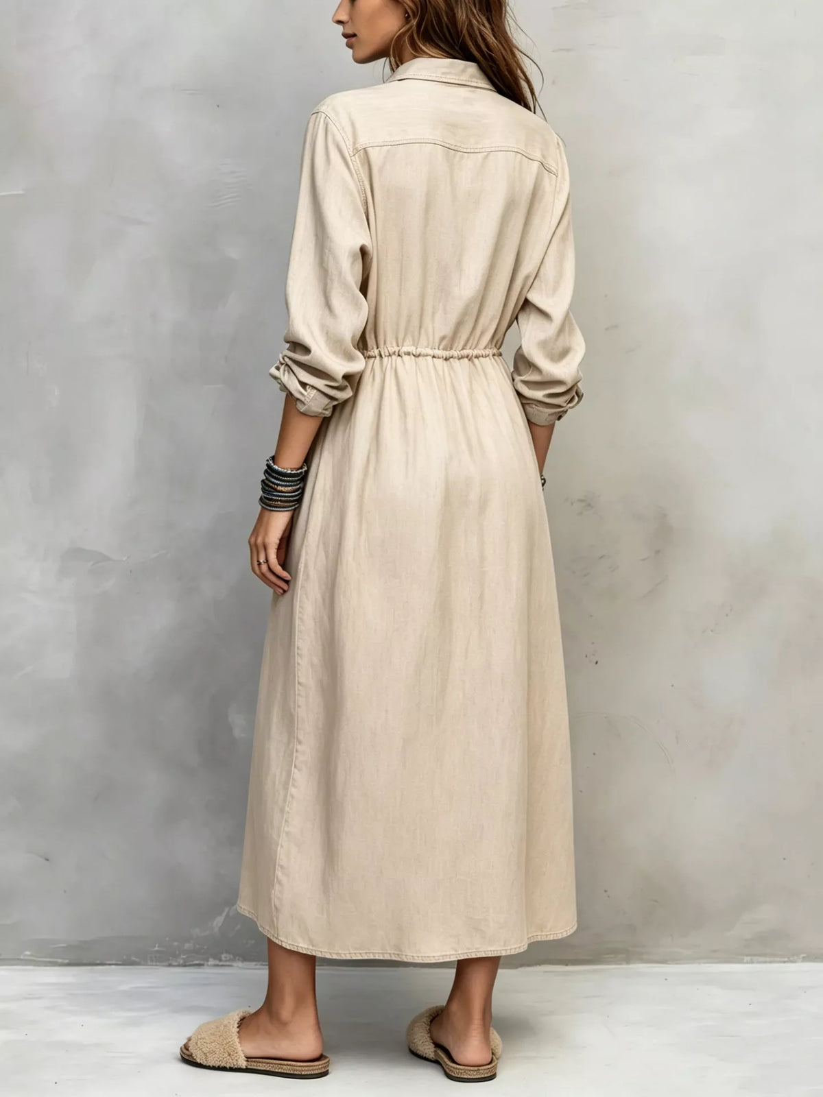 Plus size long sleeve button front shirt dress with a relaxed fit, featuring a classic collar and front buttons.