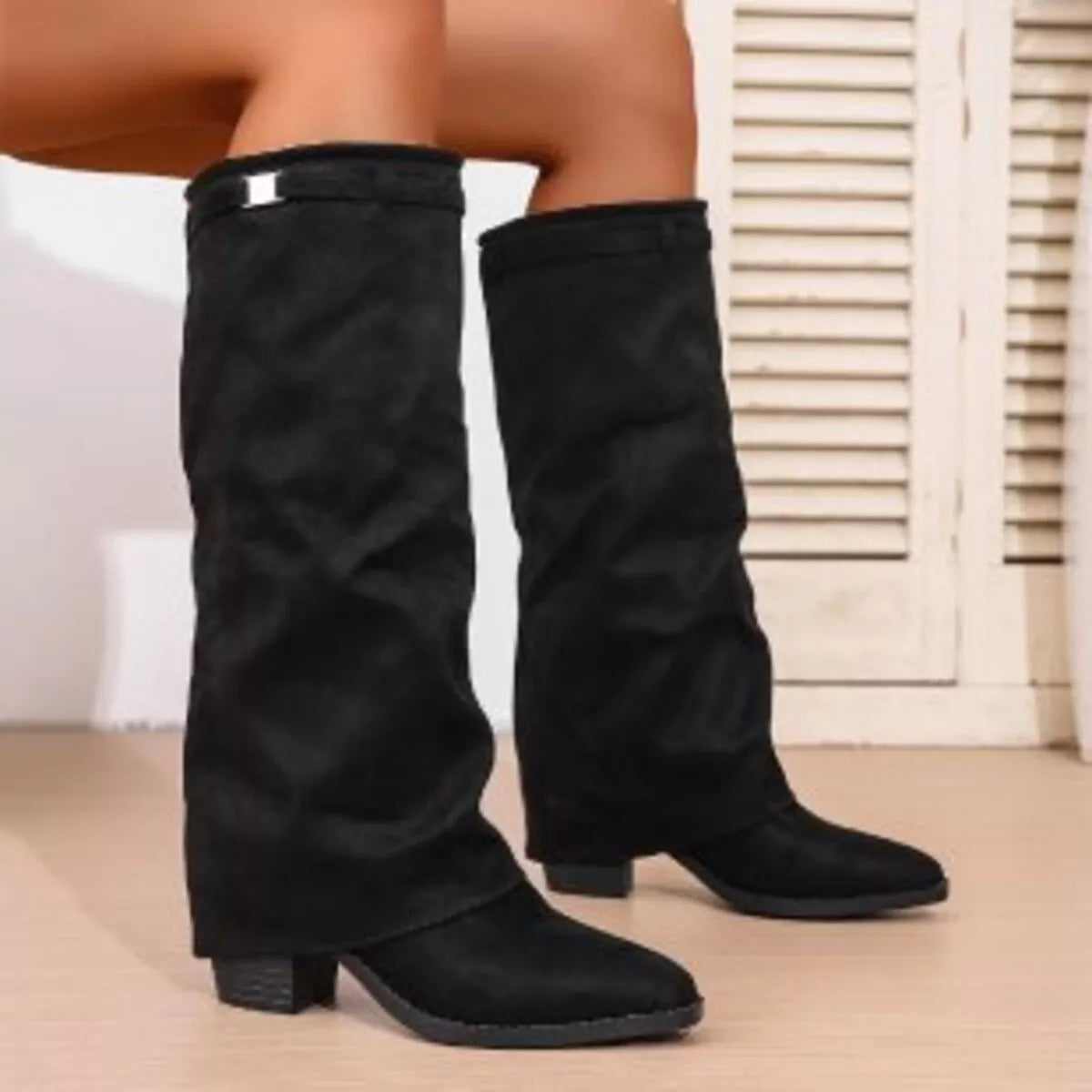 Point toe block heel boots in trendy footwear style, featuring sleek design and sturdy heel for stylish comfort.