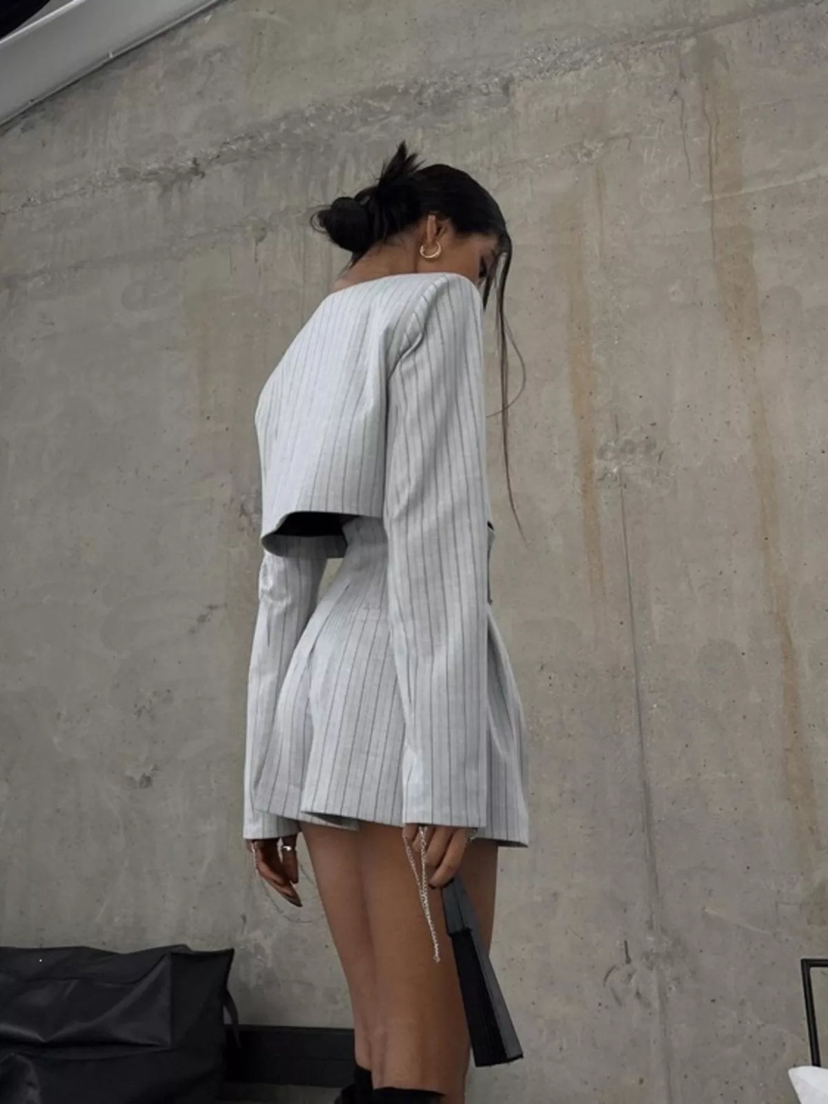 Pinstripe cropped blazer and pleated shorts set by Trendsi, featuring tailored fit and stylish pinstripe pattern.
