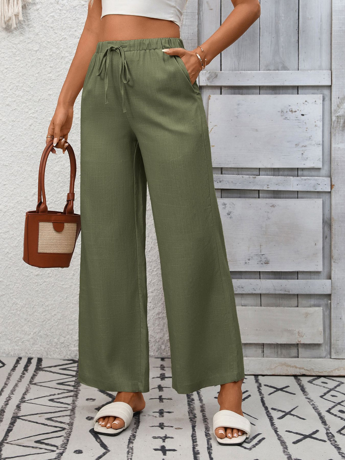 Women's high-waisted wide-leg drawstring pants in soft, breathable viscose fabric by Plush Fashion Hub, shown in a relaxed fit.