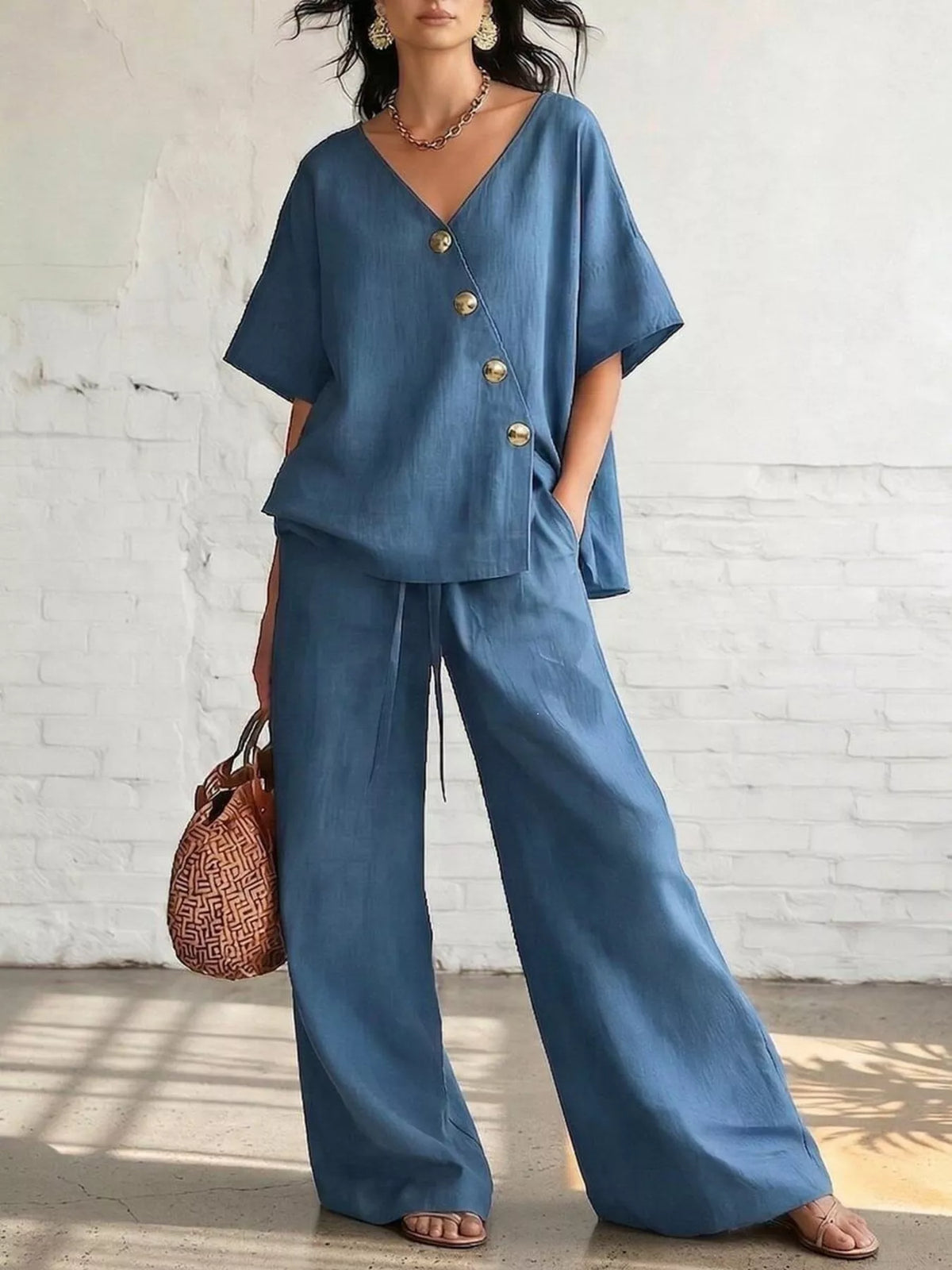 Plus size full surplice half sleeve top and wide-leg pants set from Trendsi, shown on a model, featuring a stylish matching outfit.