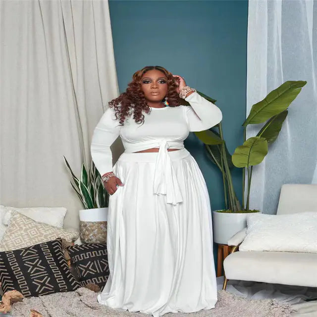 Plus size women's two-piece skirt set with long sleeves, trendy outfit featuring a stylish matching top and skirt ensemble.