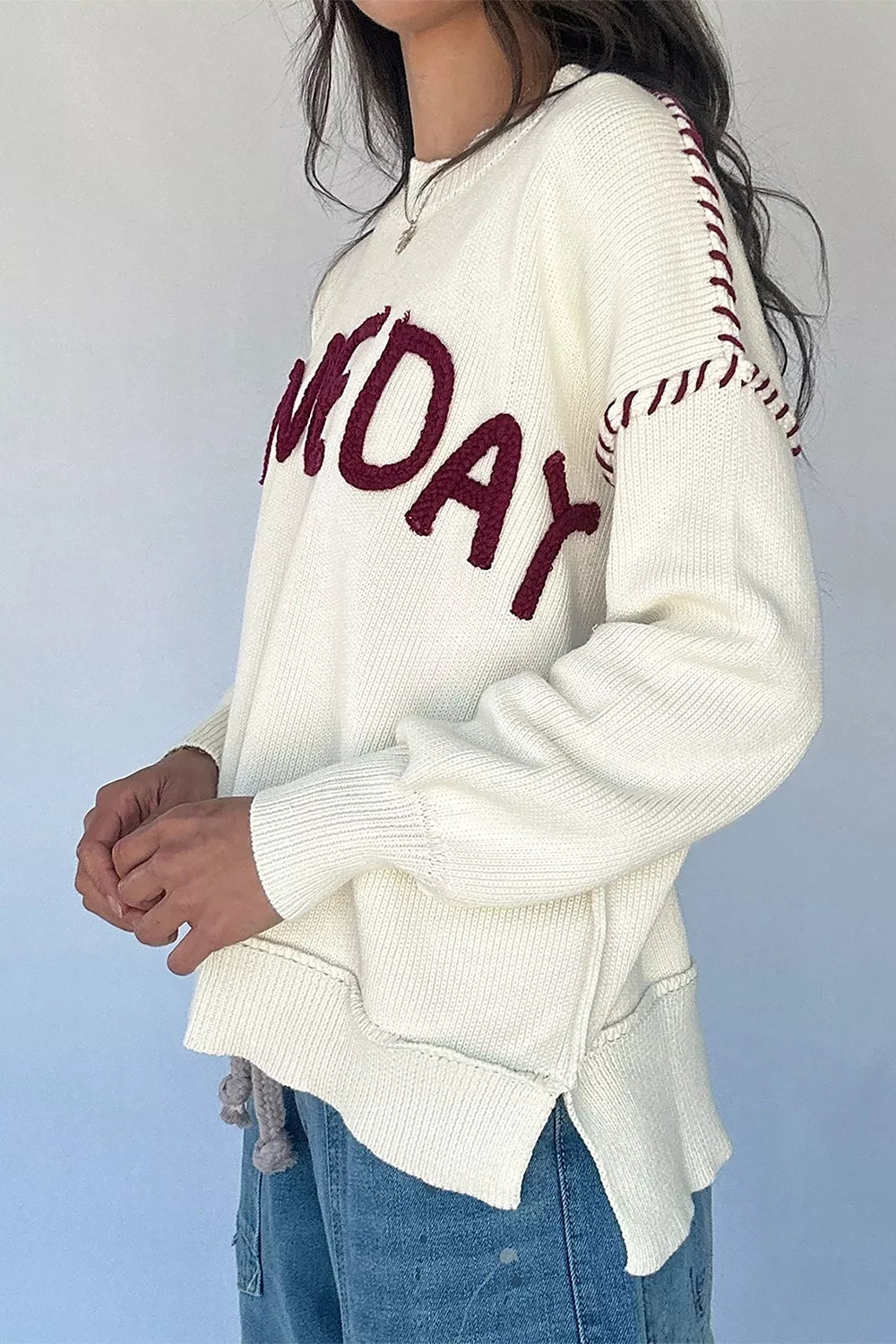 Trendsi Drop Shoulder Game Day Letter Sweater featuring a relaxed fit, soft knit fabric, and bold letter design on the front.