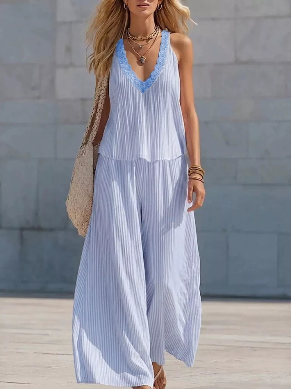 Striped V-neck tank top and wide-leg pants matching set from Plush Fashion Hub, featuring bold stripes and relaxed fit.