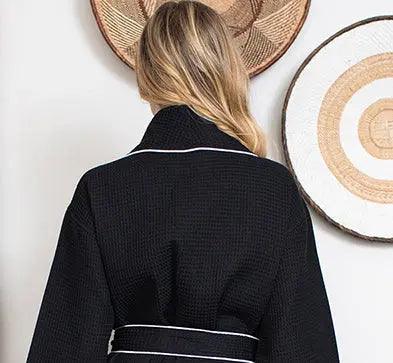 Black women's waffle piping bathrobe by Lotus Linen, lightweight spa-style robe with back detail and piping accents.