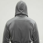 Back view of Lotus Linen men's hooded robe in grey-black plush fabric, showing soft, cozy material and hood detail.