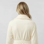 Back view of Lotus Linen women's ultra soft plush bathrobe, small size, natural color, showing cozy, plush fabric and relaxed fit.