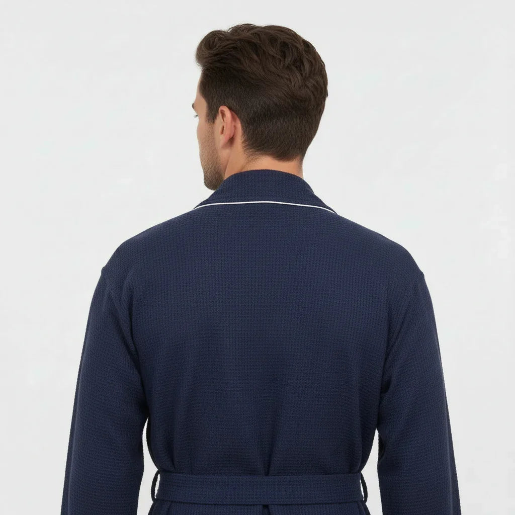 Small navy men's waffle piping robe by Lotus Linen, showing back view with contrasting piping details and soft textured fabric.