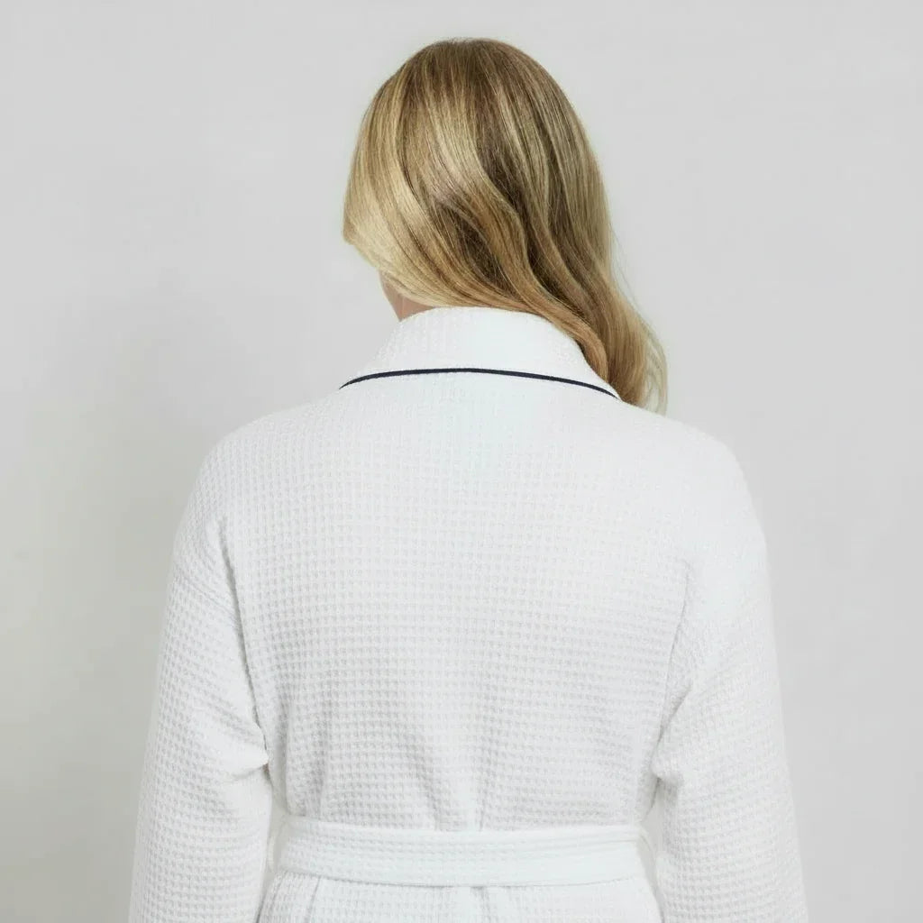 White women's waffle piping bathrobe by Lotus Linen, lightweight spa-style robe with small piping detail, shown from the back.