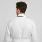 Back view of small white men's premium waffle piping robe by Lotus Linen, showing piping details and relaxed fit.