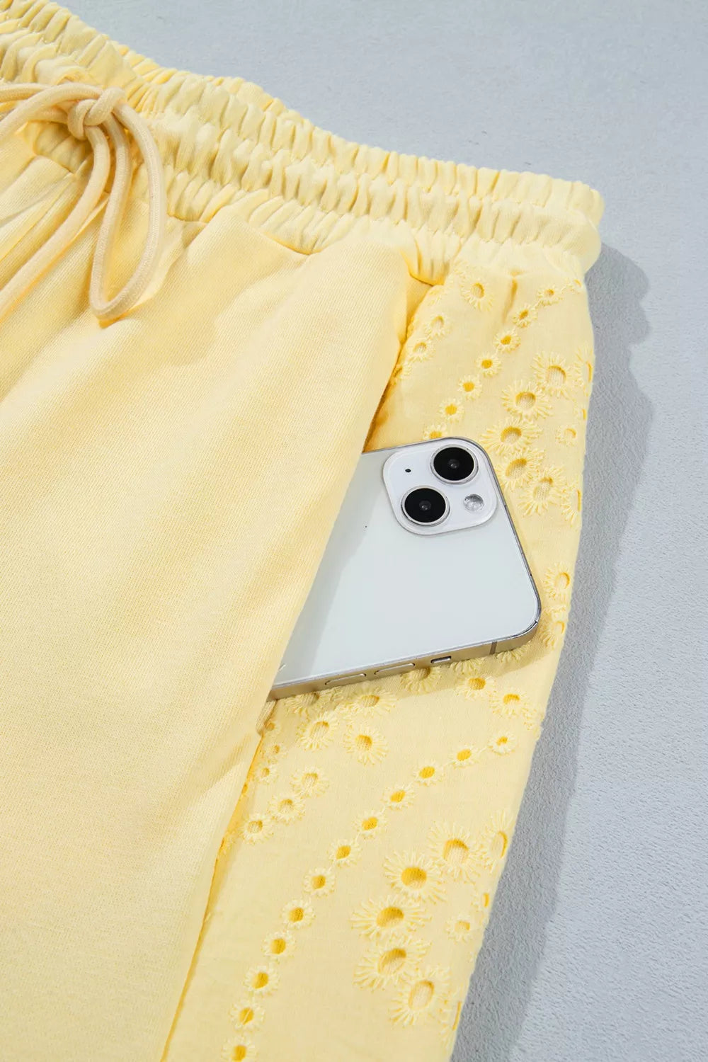 Trendsi rings set featuring a half sleeve top and drawstring pants in a stylish, modern design, displayed on a white background.