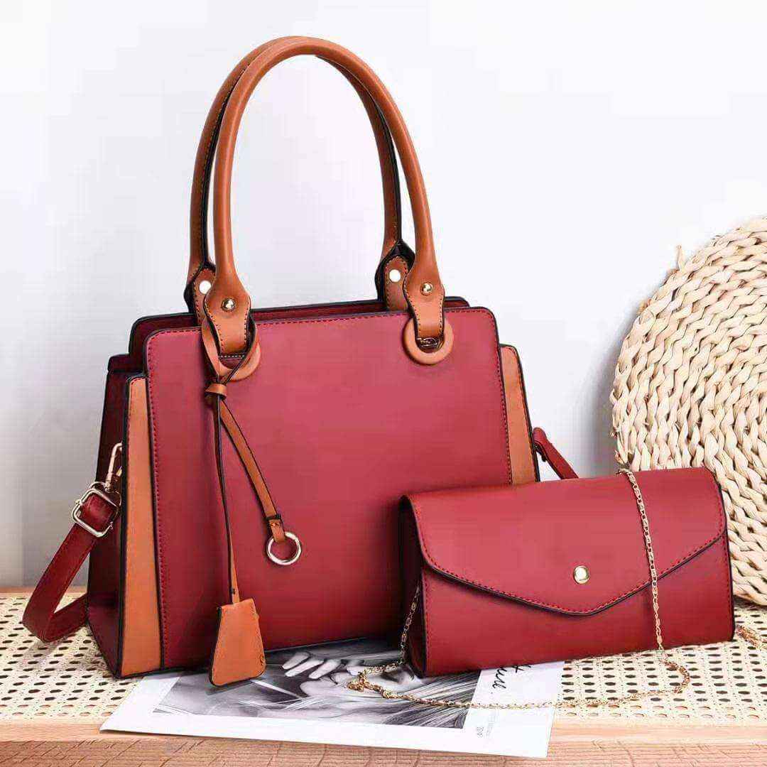 Trendy women's bags in red with matching handles and accented details.