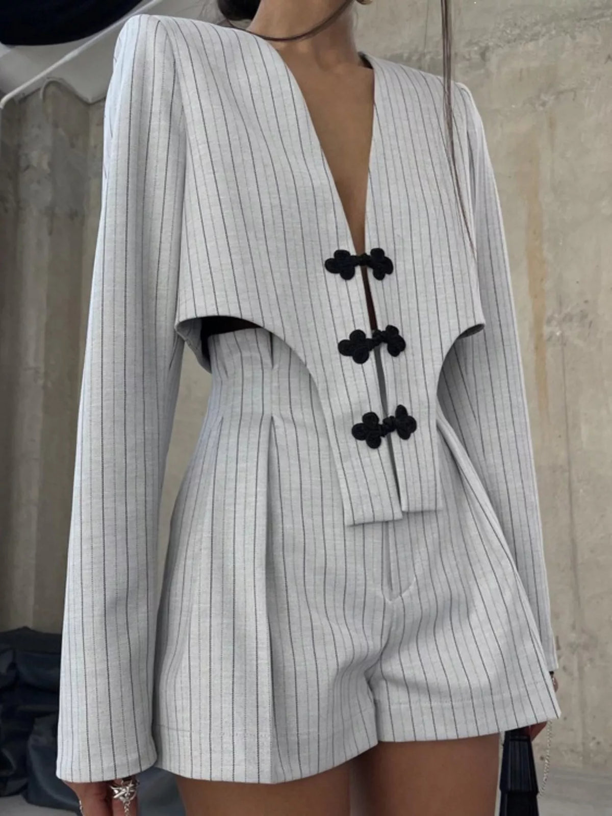 Trendsi pinstripe cropped blazer and pleated shorts set, stylish women’s fashion ensemble, featuring tailored blazer and matching shorts.