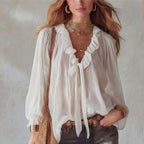 V-neck loose-fit casual shirt top by Plush Fashion Hub in beige, no-iron fabric, displayed on a hanger with multiple color options.