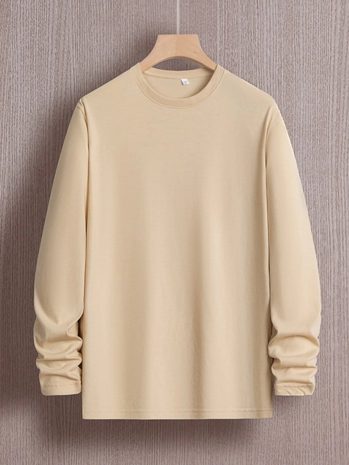 Plus size men's round neck long sleeve T-shirt by Trendsi, shown in a versatile design with a comfortable fit.