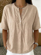 Women's solid color loose-fit short-sleeve pullover top by FitiqueFit, casualwear, displayed on a hanger with a relaxed fit.