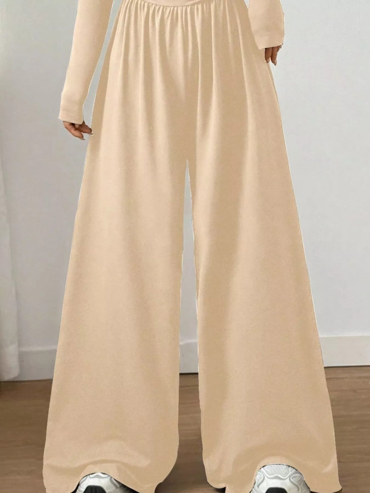 Trendsi ruched square neck wide-leg jumpsuit with fitted bodice and flowing pant legs, shown in a stylish, casual fit.
