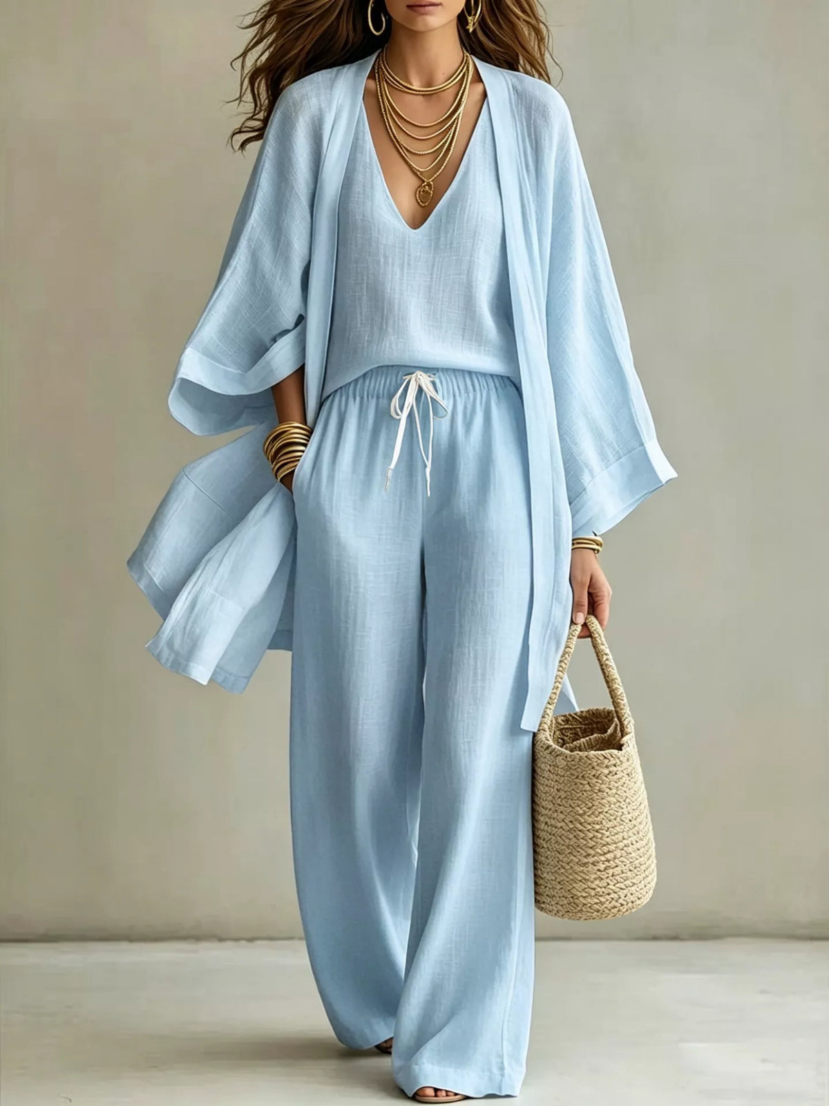 Plus size V-neck tank cardigan and pants loungewear set by Trendsi, featuring a comfortable, coordinated knit fabric in relaxed fit.