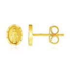 14k yellow gold oval religious medallion post earrings with detailed design, crafted by Bids.com.
