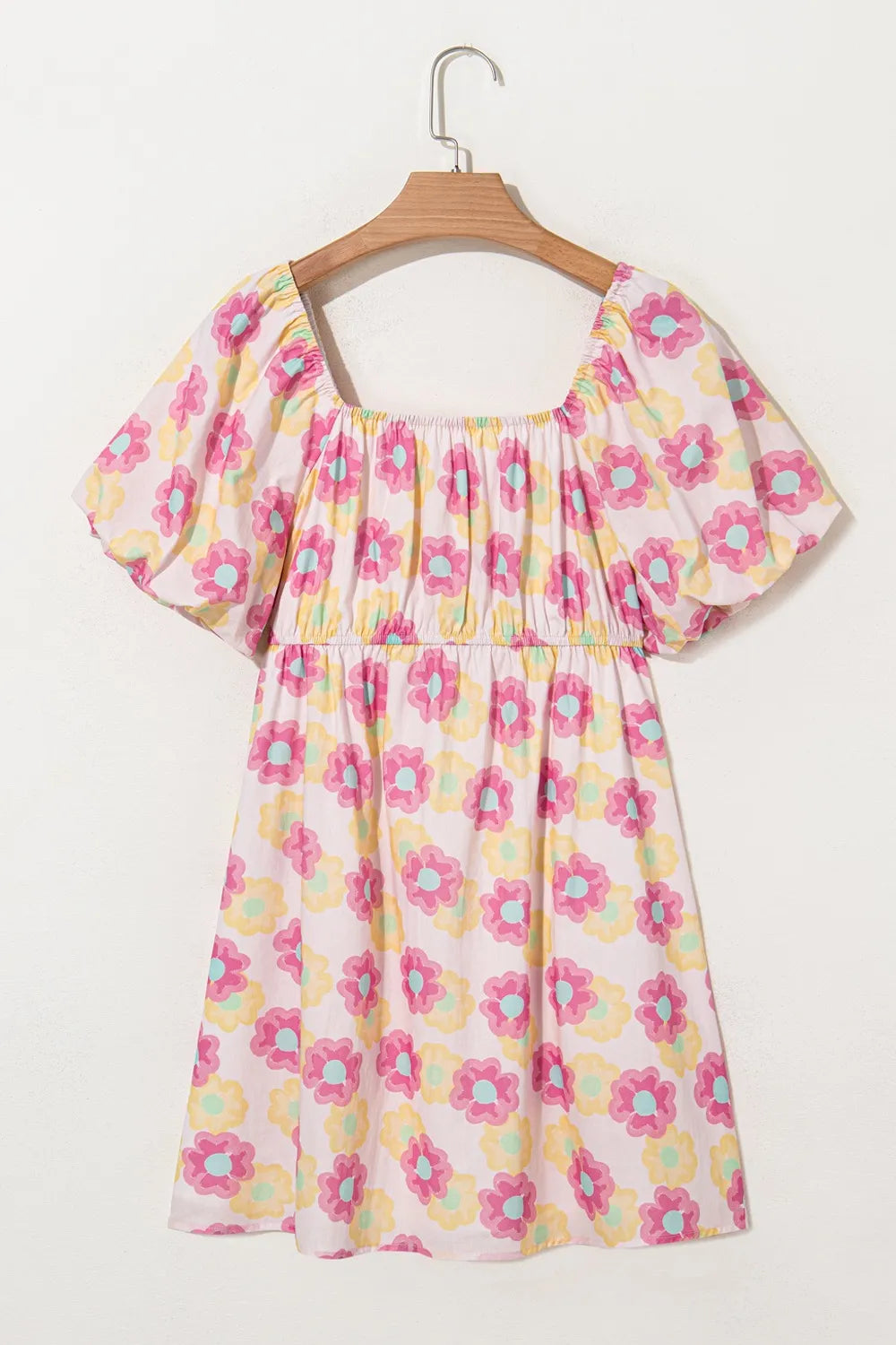 Floral square neck puff sleeve cotton midi dress with pleated flared skirt, trendy design, worn by a model showing the full dress.