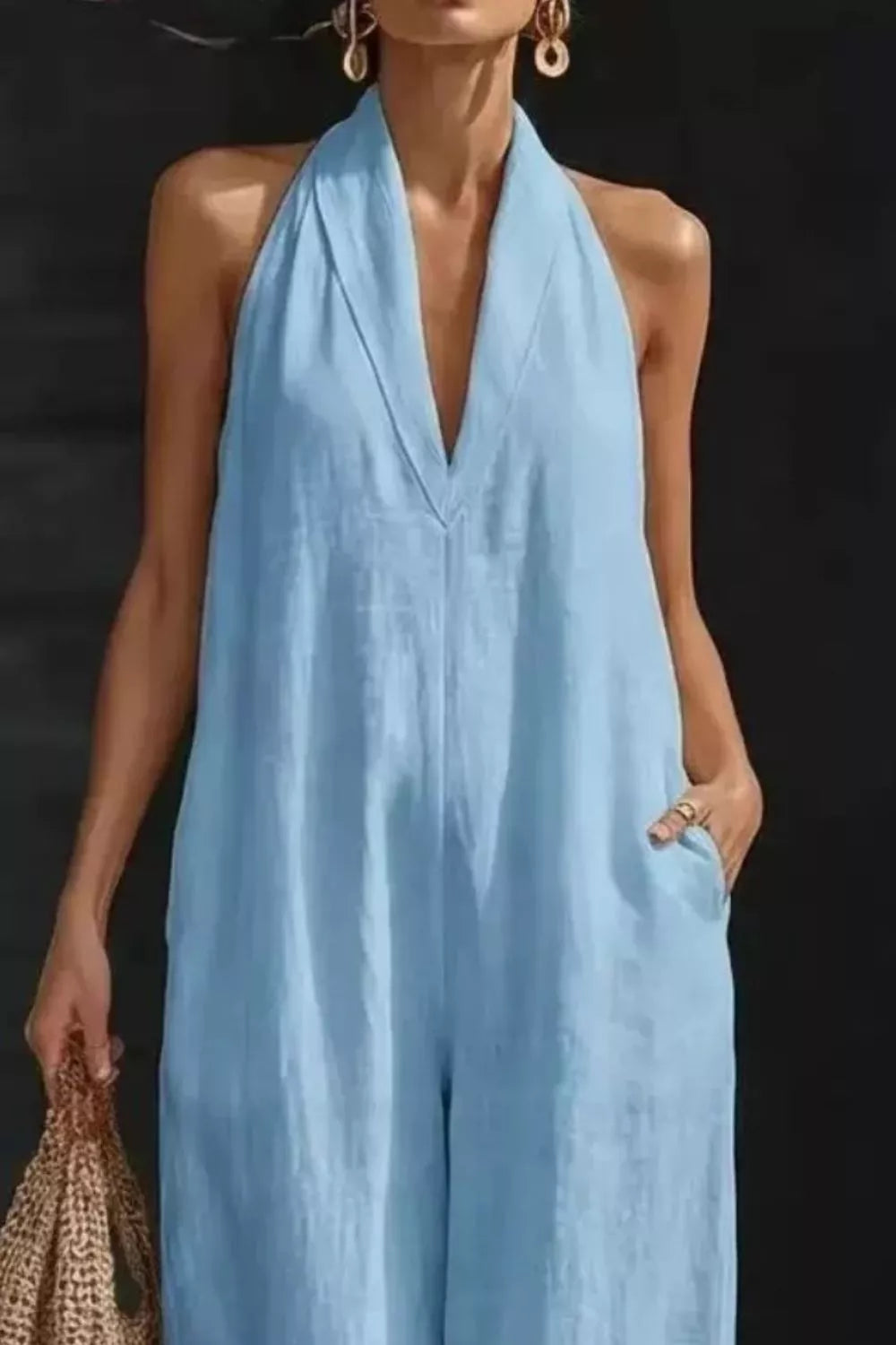 Women's sleeveless wide-leg jumpsuit with pockets, casual romper from Plush Fashion Hub, shown in a stylish, relaxed fit design.