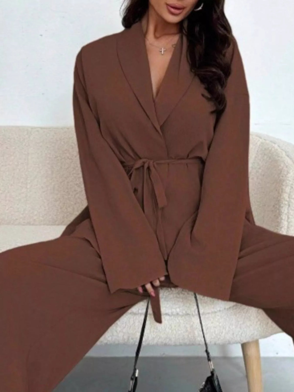 Textured tie waist top and wide-leg pants set for women by Trendsi, featuring a stylish coordinated outfit with a textured fabric.