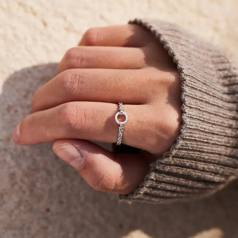 Sterling silver ring with inlaid zircon stones, featuring a polished band and elegant design from Plush Fashion Hub.