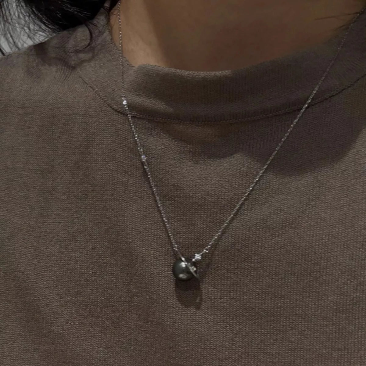 Plush Fashion Hub Planet Pearl Pendant Necklace featuring a spherical pearl pendant on a delicate chain.