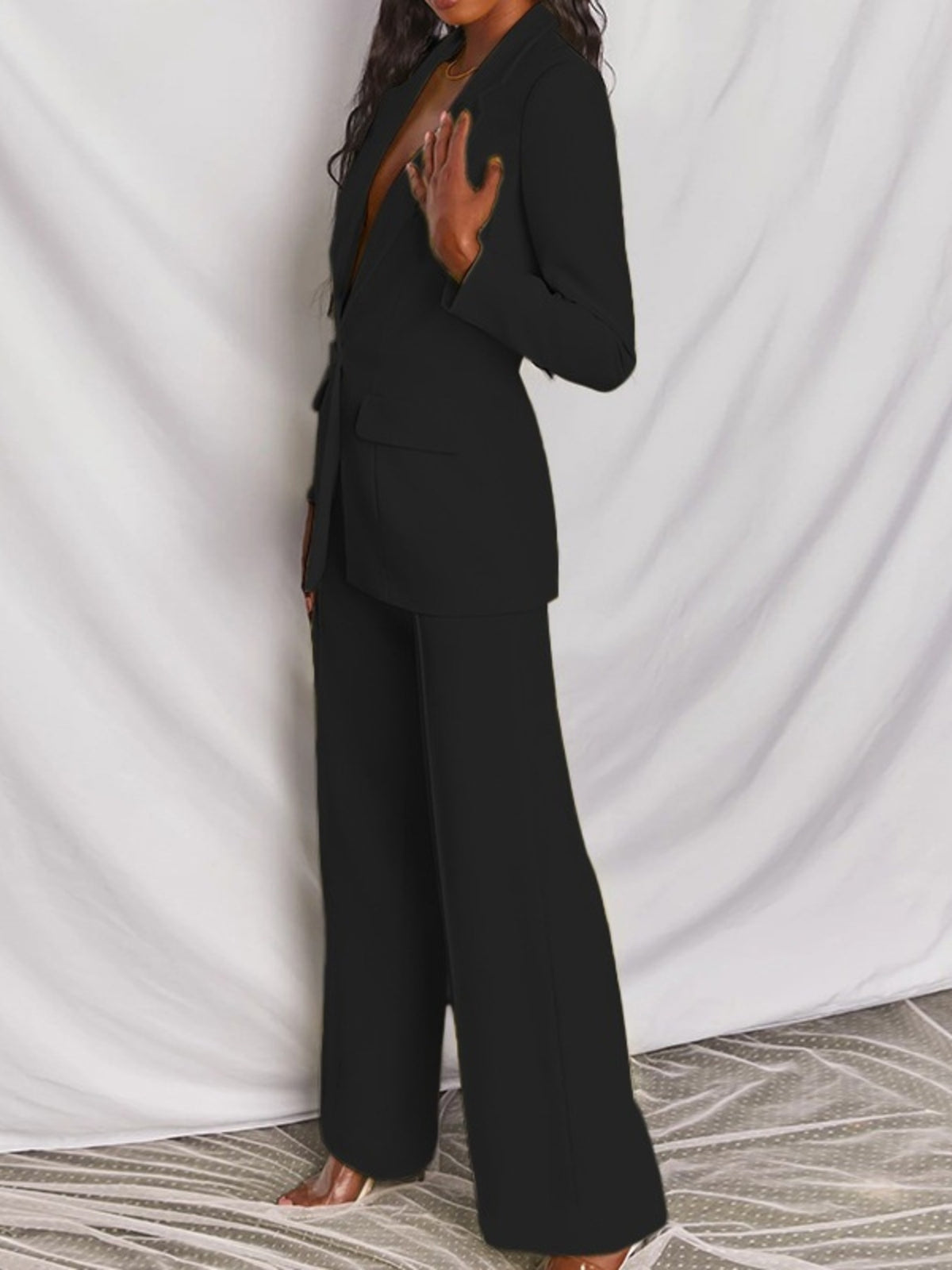Plus size blazer and wide-leg pants matching set by Trendsi, featuring a single-button blazer and flowing wide-leg trousers.