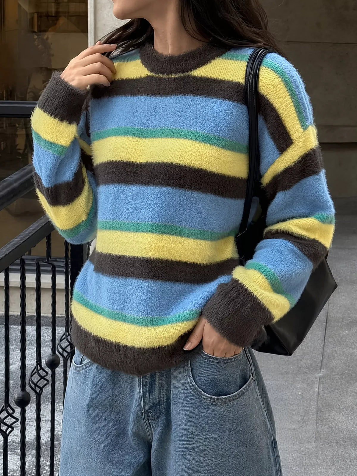 Striped dropped shoulder sweater by Trendsi featuring a relaxed fit and bold horizontal stripes in various colors.