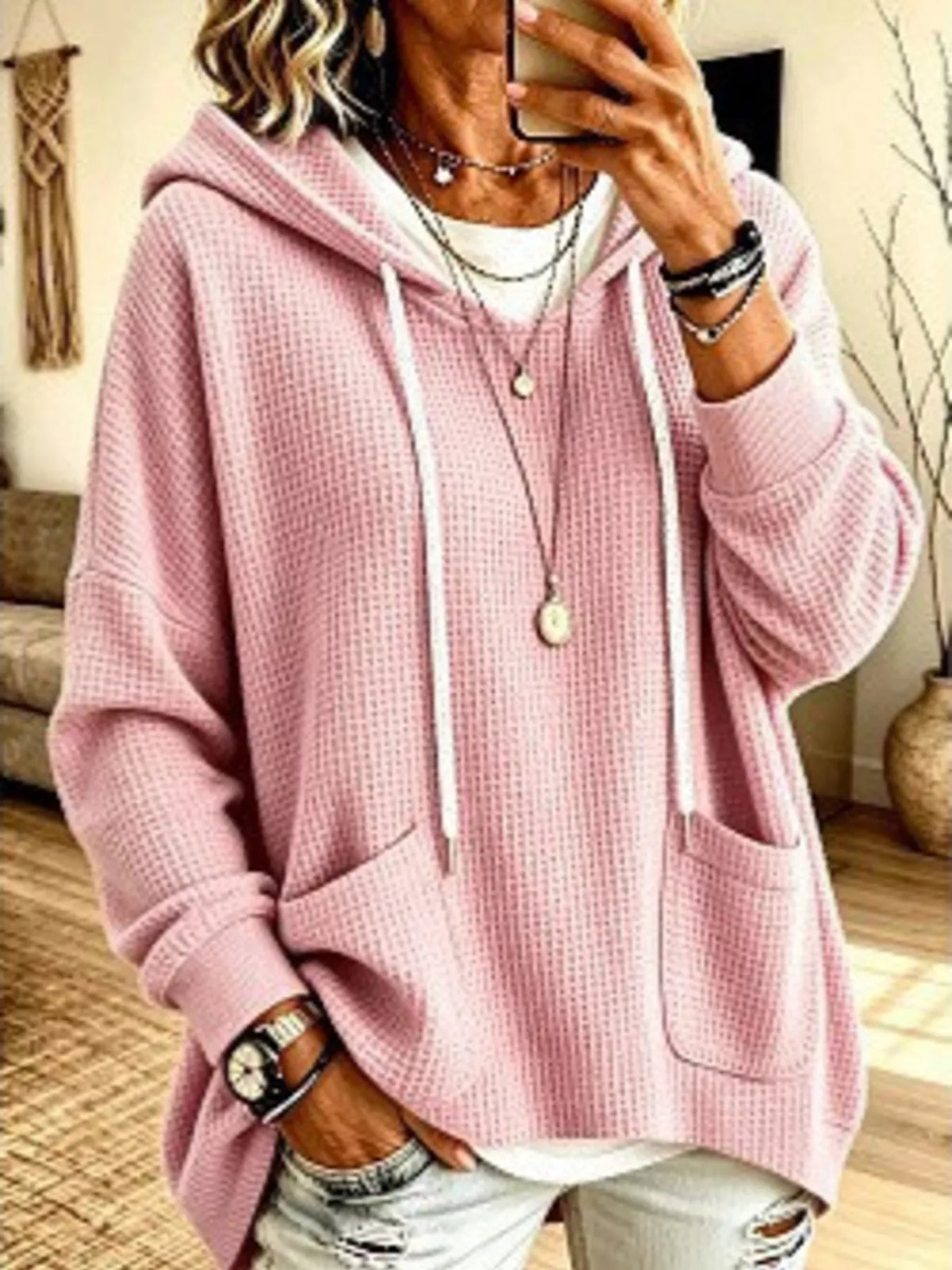 Plus size women's waffle knit hoodie with pockets from Trendsi, showing the soft, cozy fabric and front pocket details.