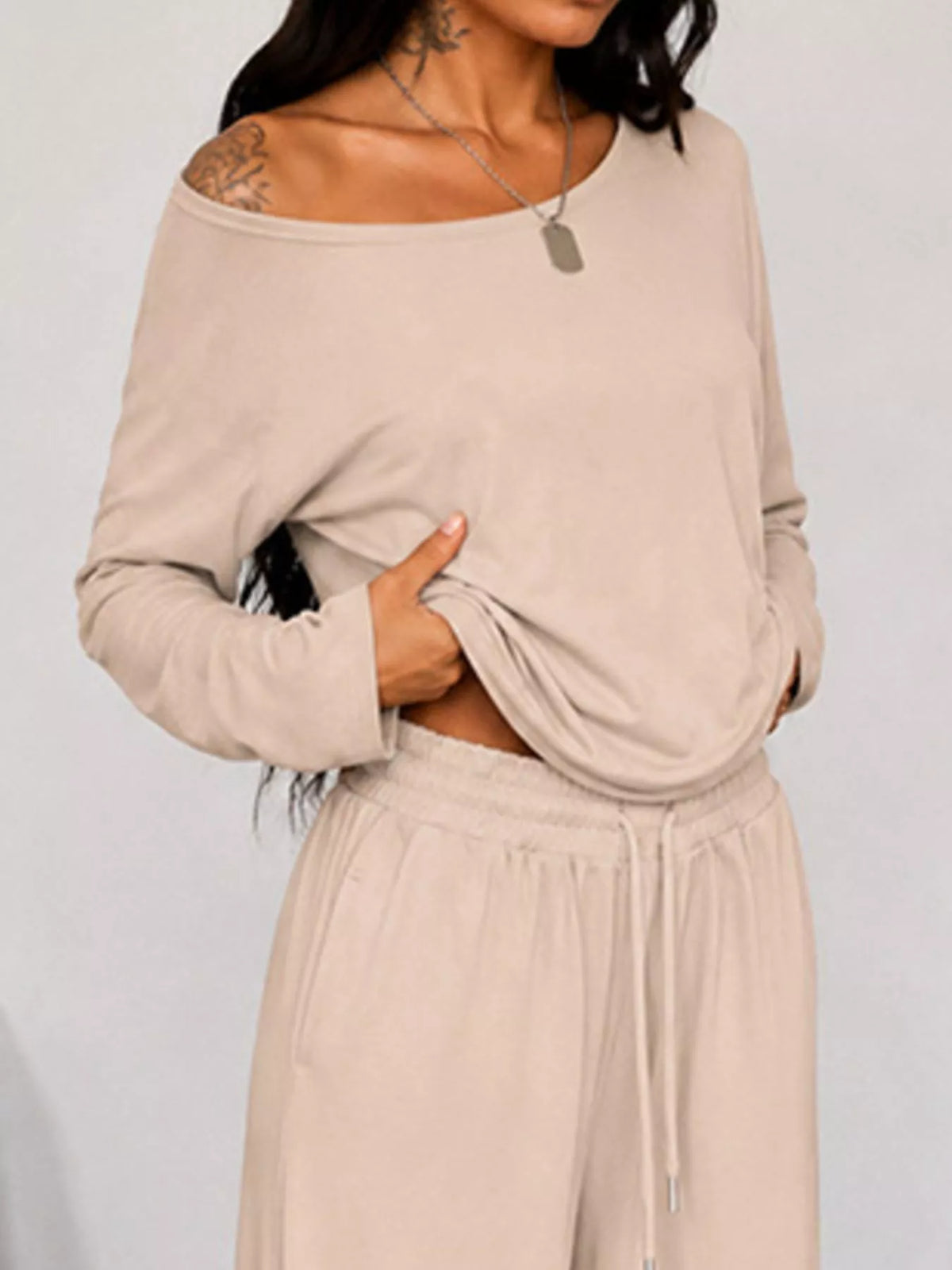 Plus size one-shoulder top and drawstring pants set from Trendsi, featuring a stylish matching ensemble in a full size.