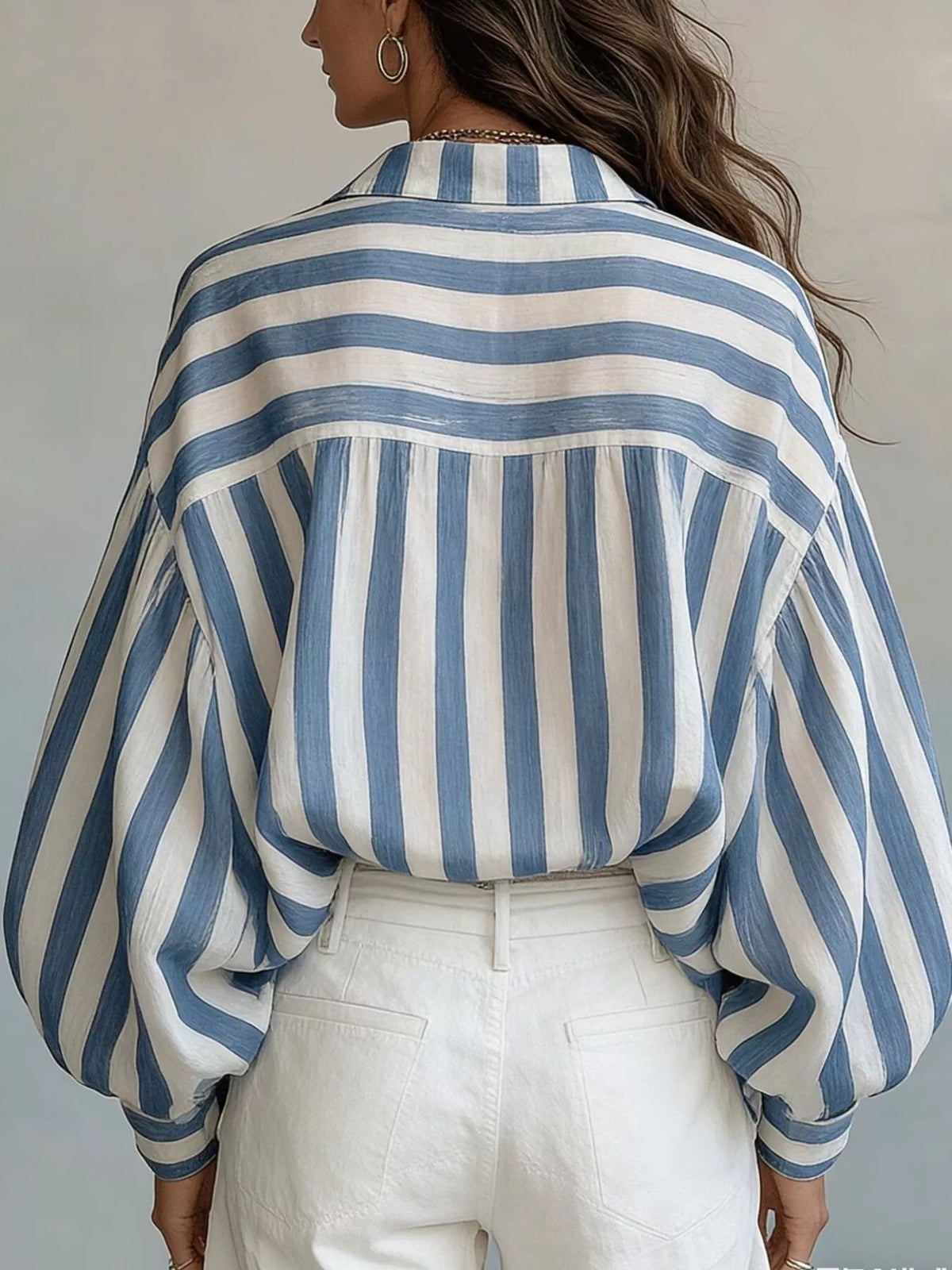 Women’s striped loose fit shirt by Trendsi featuring lightweight fabric and relaxed style, shown on a model.