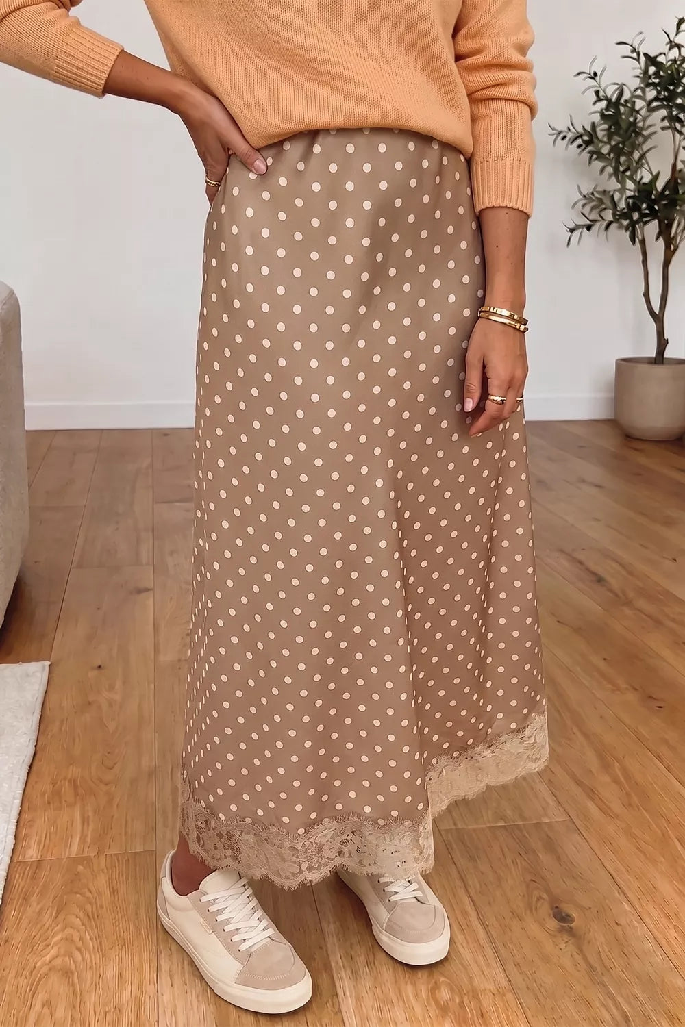 Women's polka dot lace trim midi skirt by Trendsi, featuring a flowy design with classic polka dot pattern and delicate lace details.