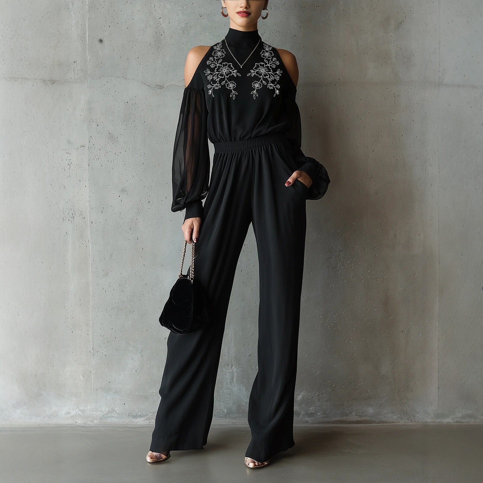 Black embroidered women's long-sleeve wide-leg jumpsuit by FitiqueFit, featuring casual style and relaxed fit for comfortable wear.