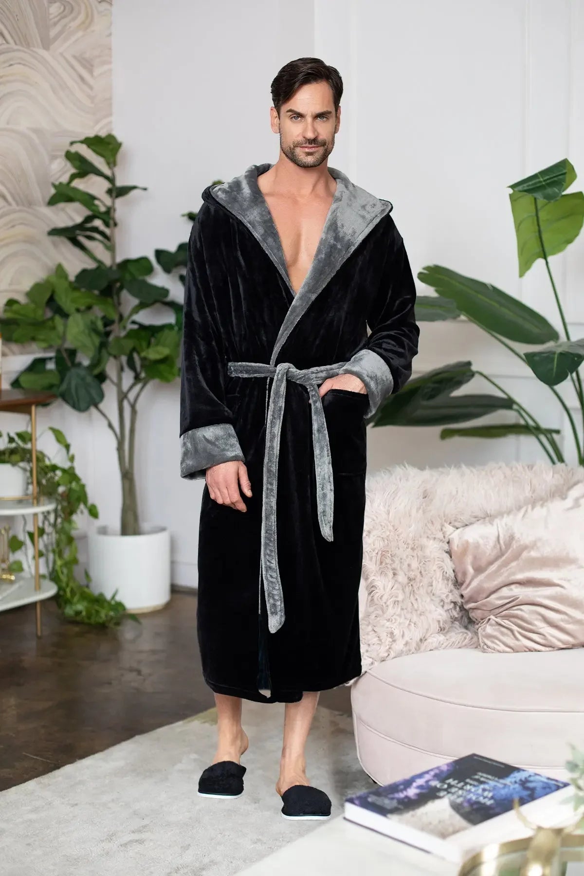 Black men's hooded robe by Lotus Linen, made from ultra-soft plush fabric, displayed hanging with a cozy, relaxed fit.