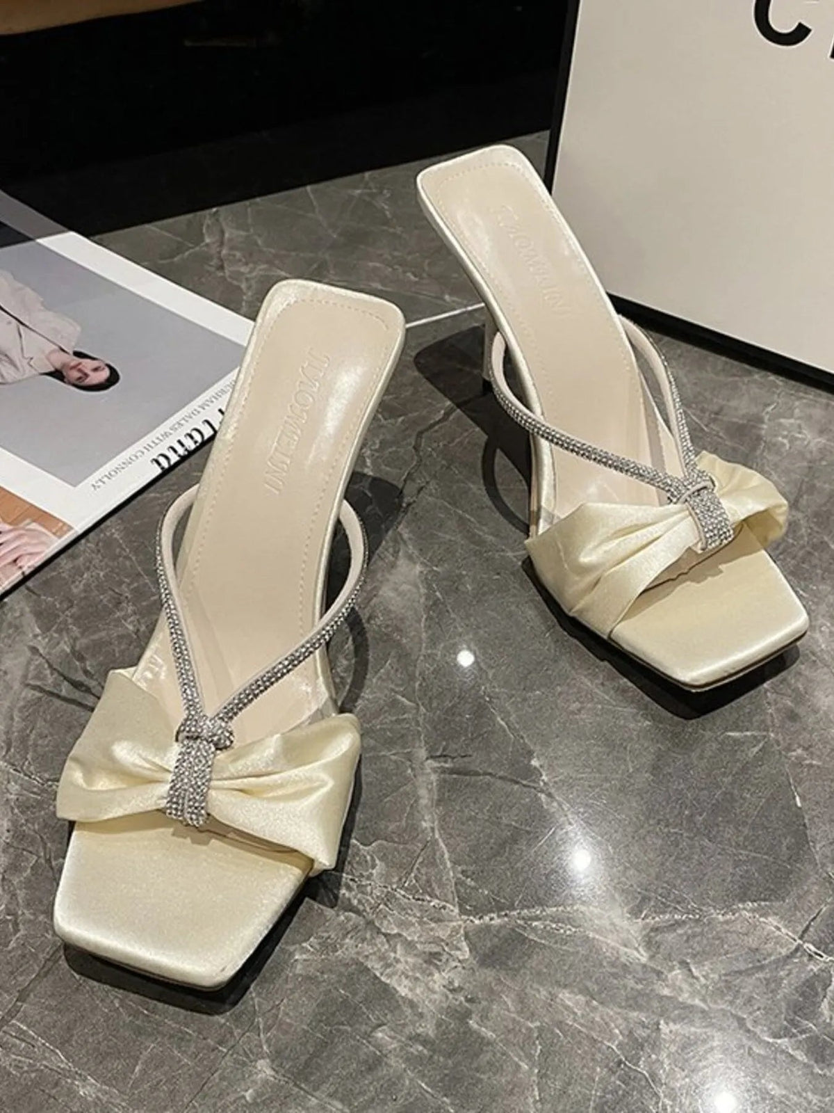 Elegant faux leather mid-heel sandals with bow detail for women, featuring a stylish design and comfortable fit by Plush Fashion Hub.