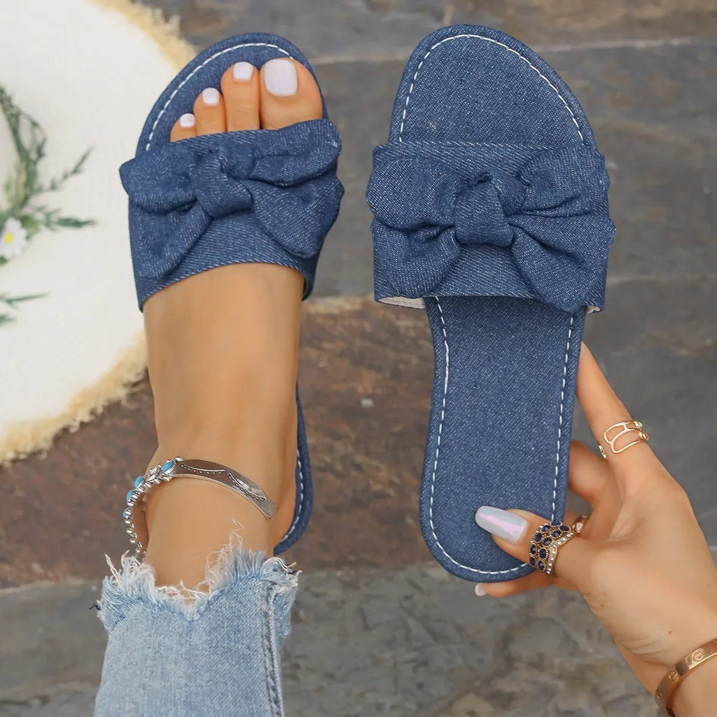 Women's denim flat sandals with bow tie detail, casual PU leather comfort shoes by Trendsi.