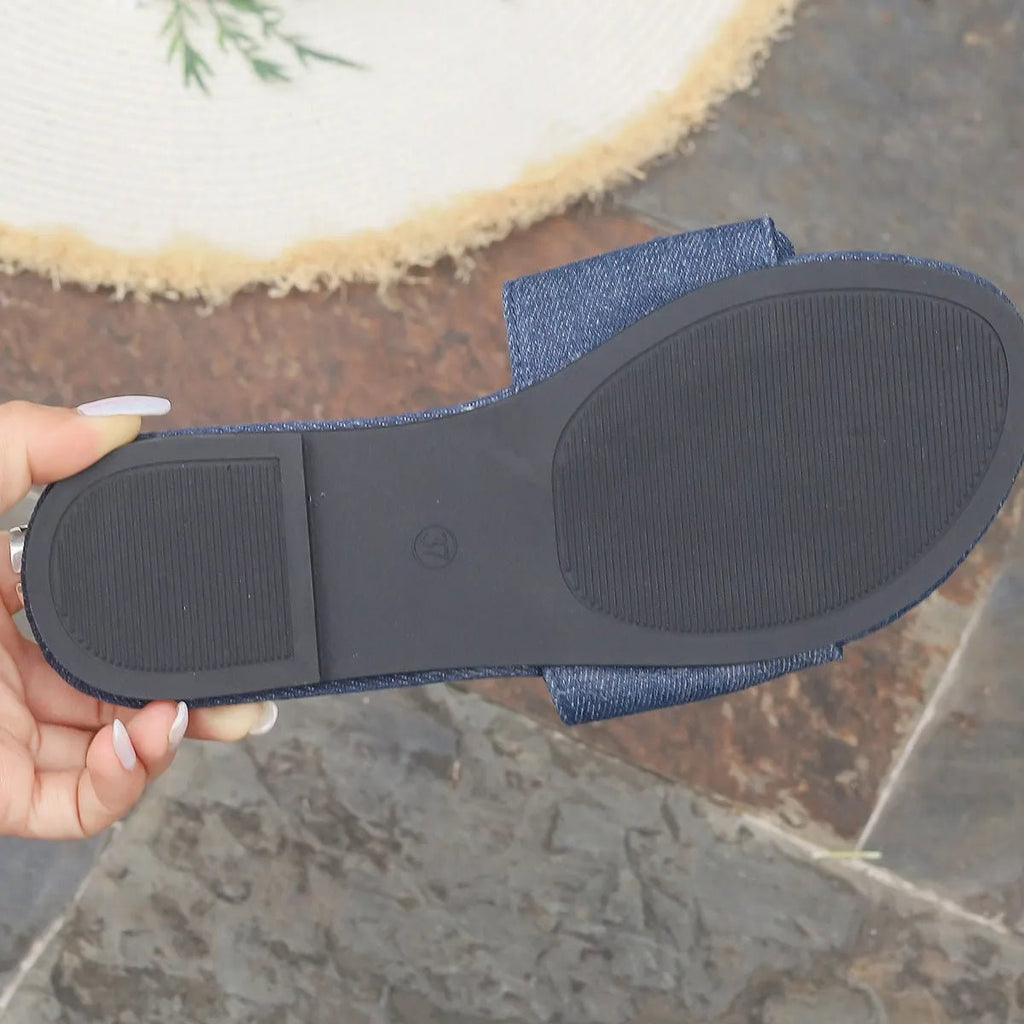 Women's denim flat sandals with bow tie detail, casual PU leather shoes by Trendsi, comfortable slip-on footwear for warm weather.