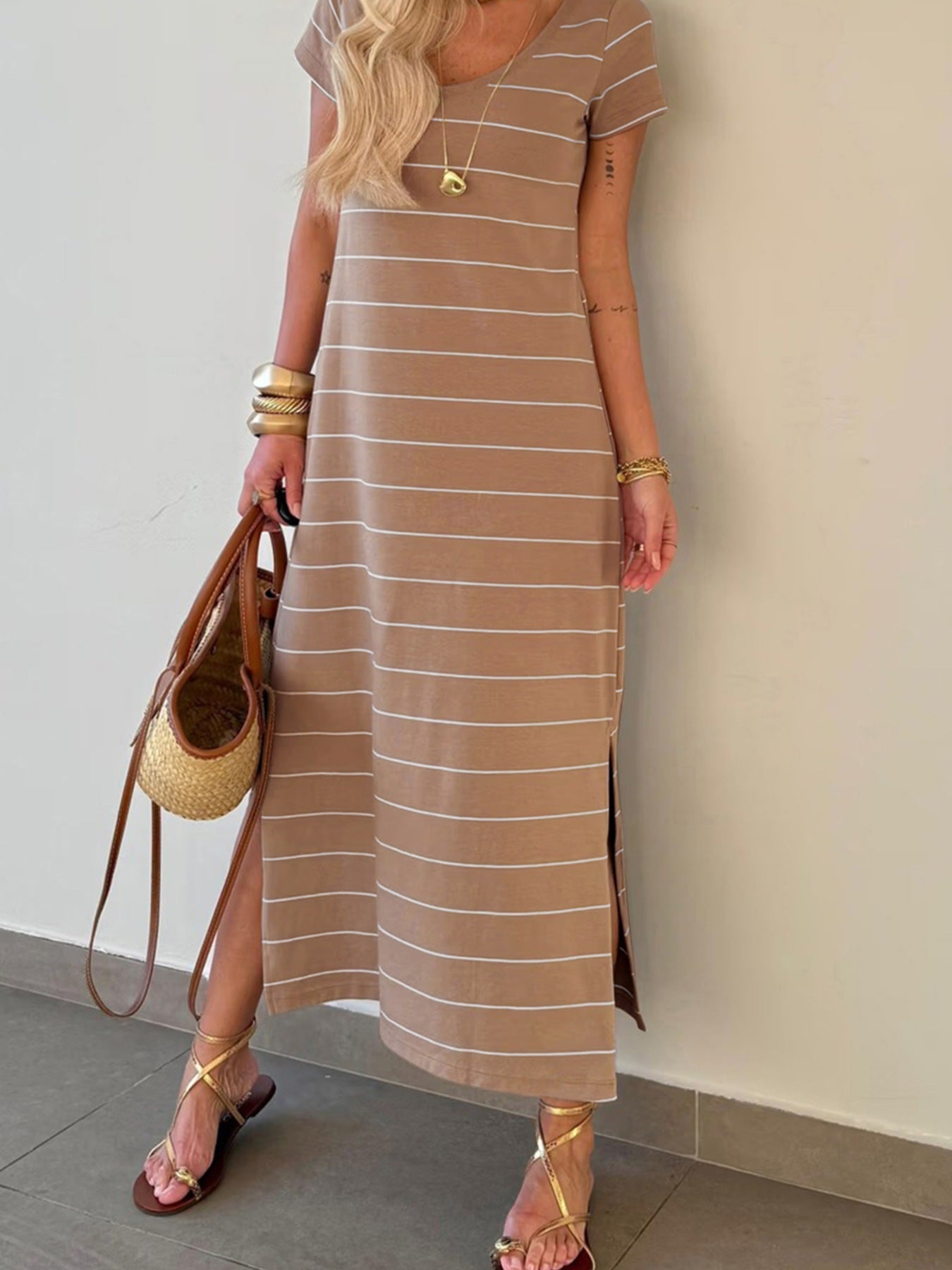 Women's striped short sleeve maxi T-shirt dress with side slit, casual trendy dress by Trendsi, featuring a comfortable fit and bold pattern.
