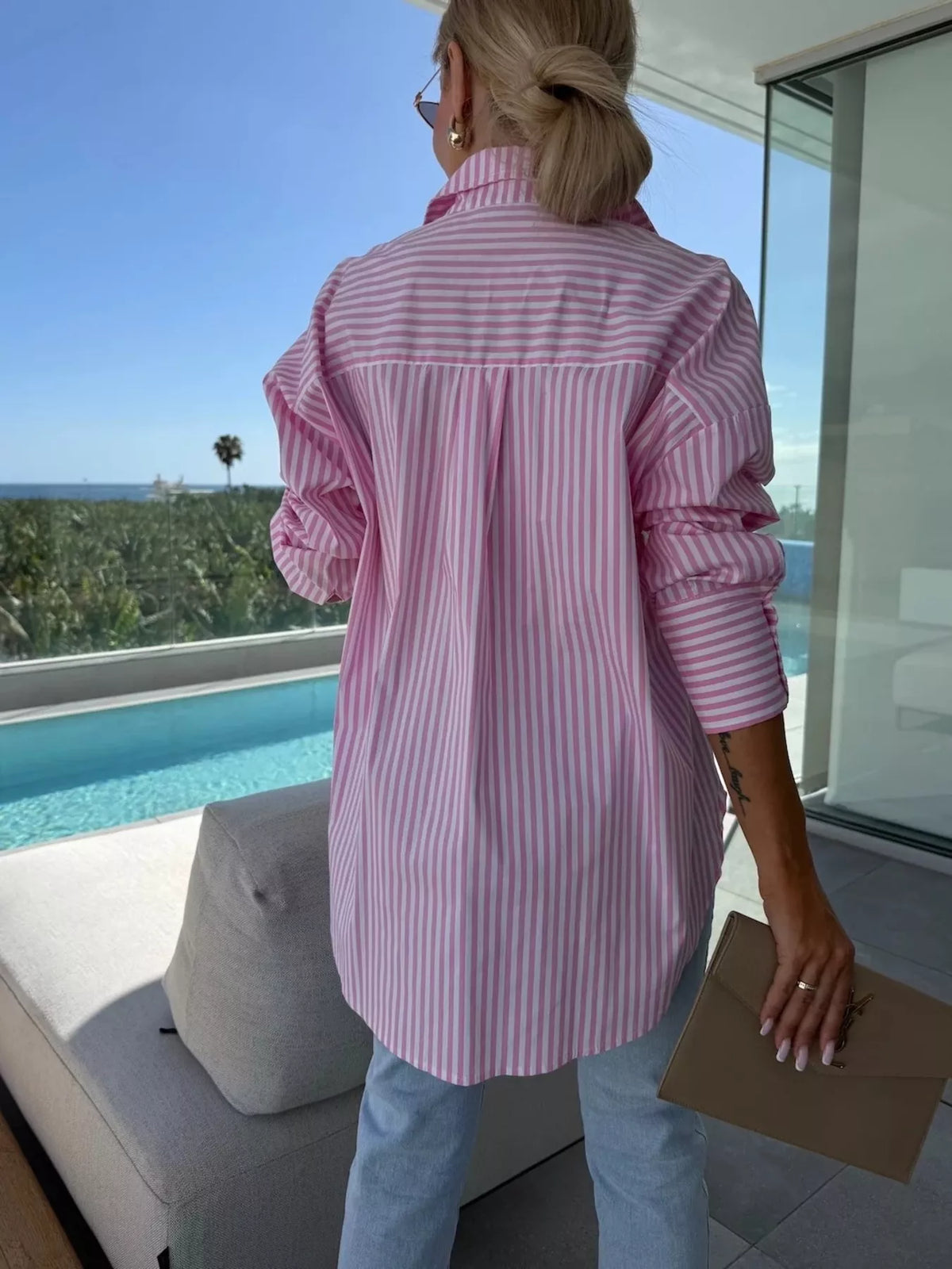 Women's long sleeve striped button-up shirt by Trendsi, featuring a classic design with vertical stripes and a collar.