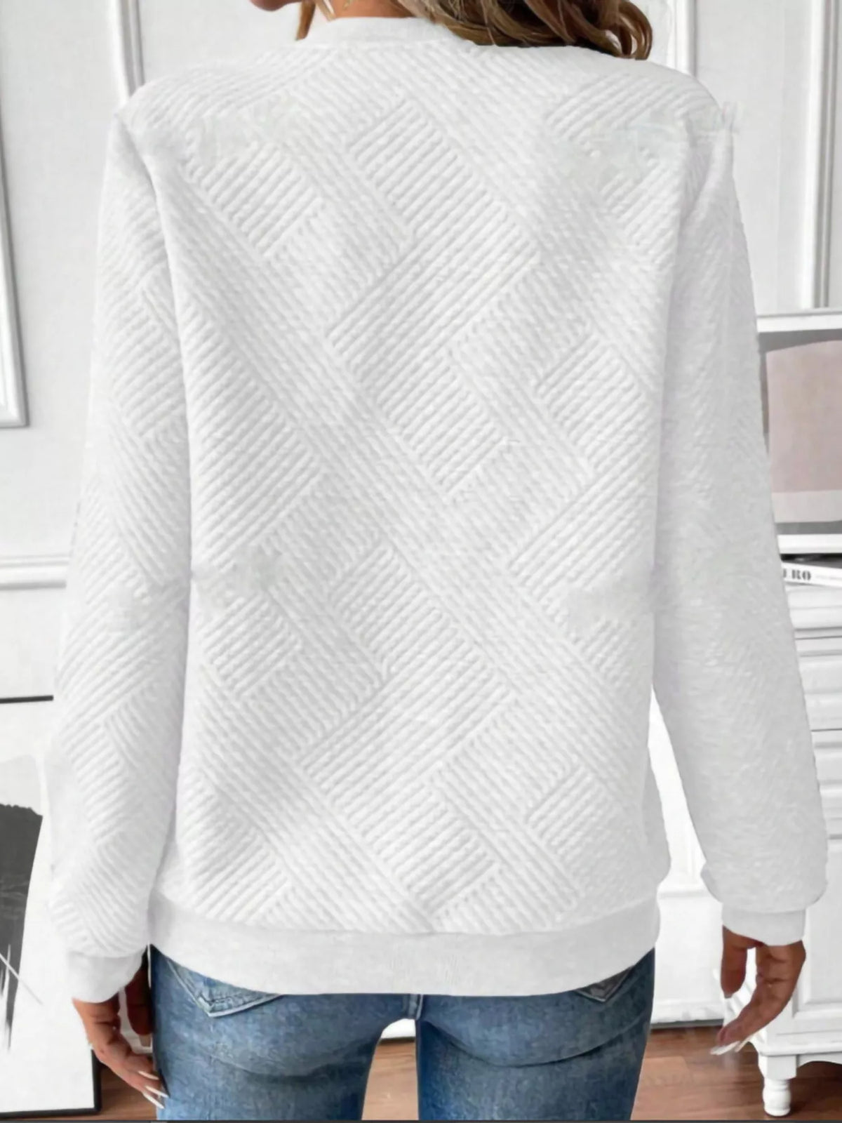 Textured women's quarter-zip sweatshirt by Trendsi, showing close-up of fabric detail and zipper on the stylish sweatshirt.